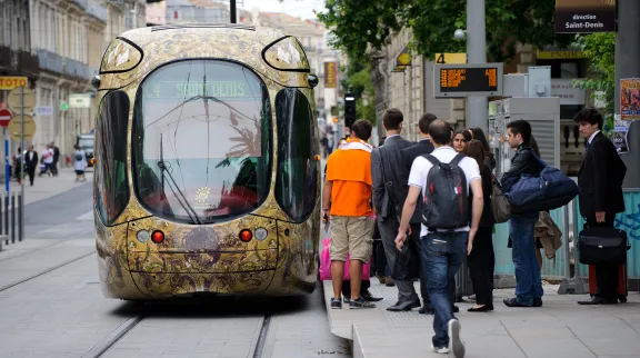 Photo de passagers qui vont monter dans un tramway, à Montpellier